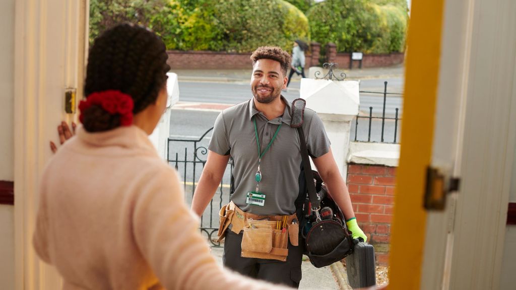 a handyman being greeted at a customers front door