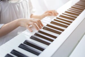 Woman playing electric piano.