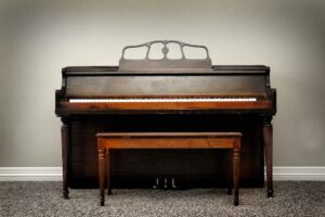 Upright piano sitting in living room of home.