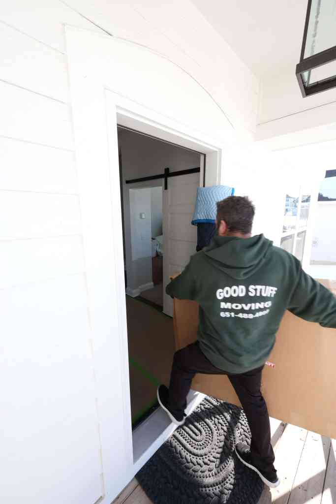 Man moving package into house