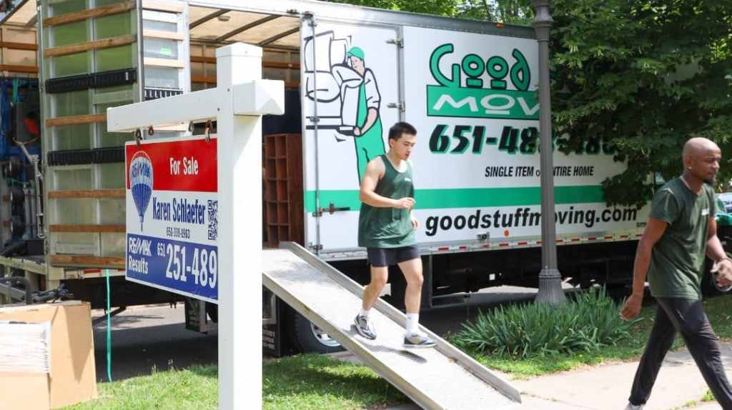 Team members loading boxes into a moving truck