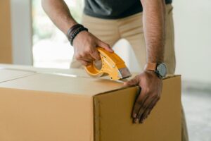 Person taping up moving boxes