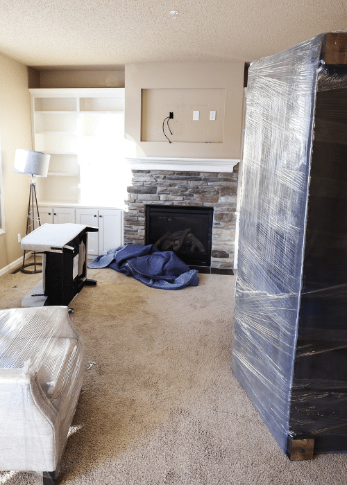 living room full of wrapped furniture