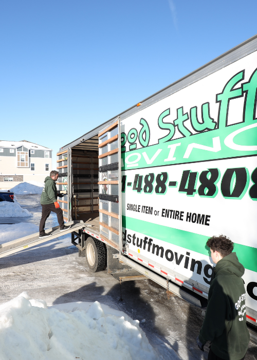 Areas We Serve 6 Two movers, one is walking up the moving truck ramp