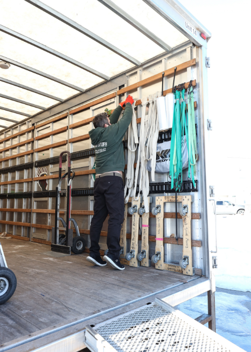 Areas We Serve 7 Team member hanging up packing materials and tools