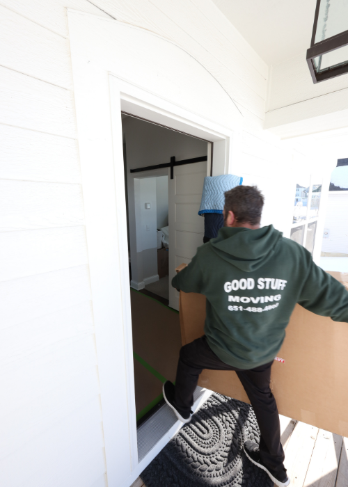 Areas We Serve 8 Team member carrying large box into a house