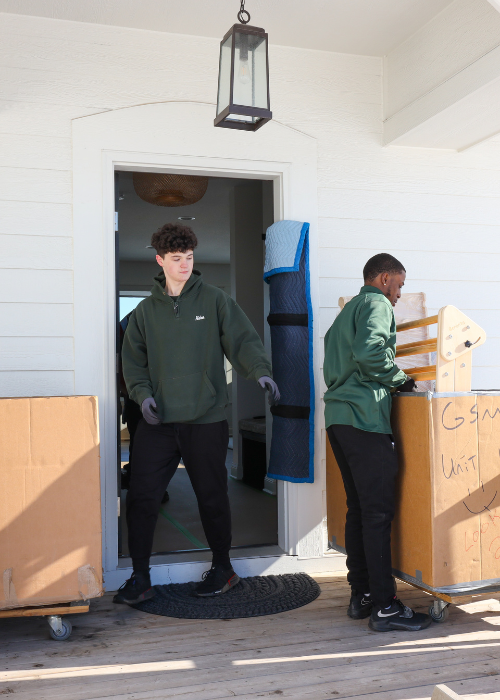 Areas We Serve 3 two good stuff moving team members loading boxes outside of a house