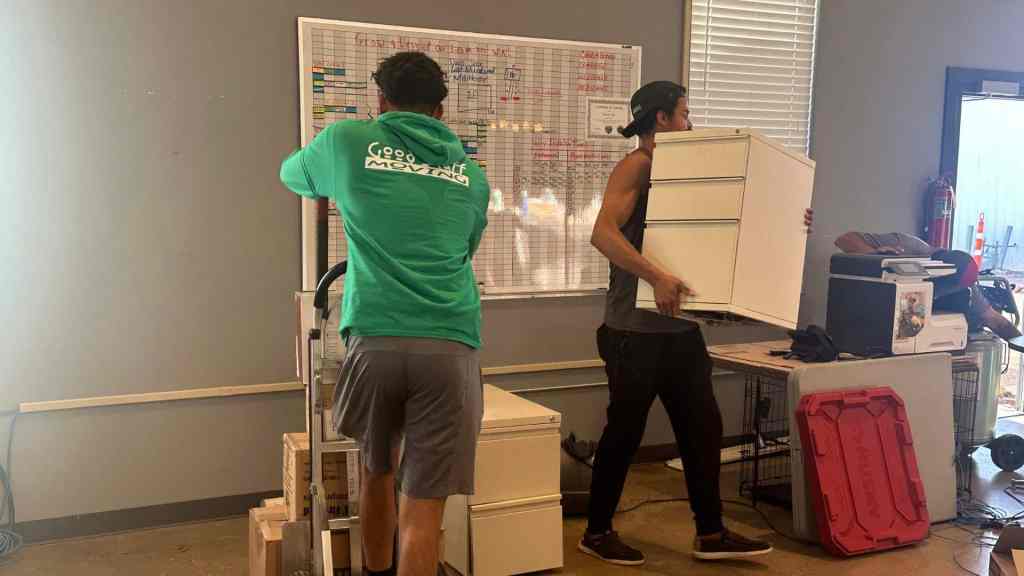 good stuff team members loading filing cabinets