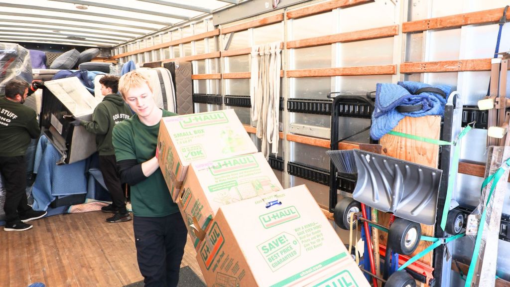 good stuff team member unloading boxes on a dolly