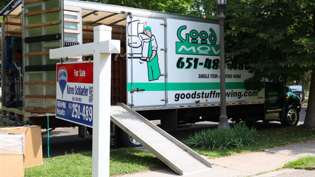 Good Stuff Moving truck parked outside a house for sale