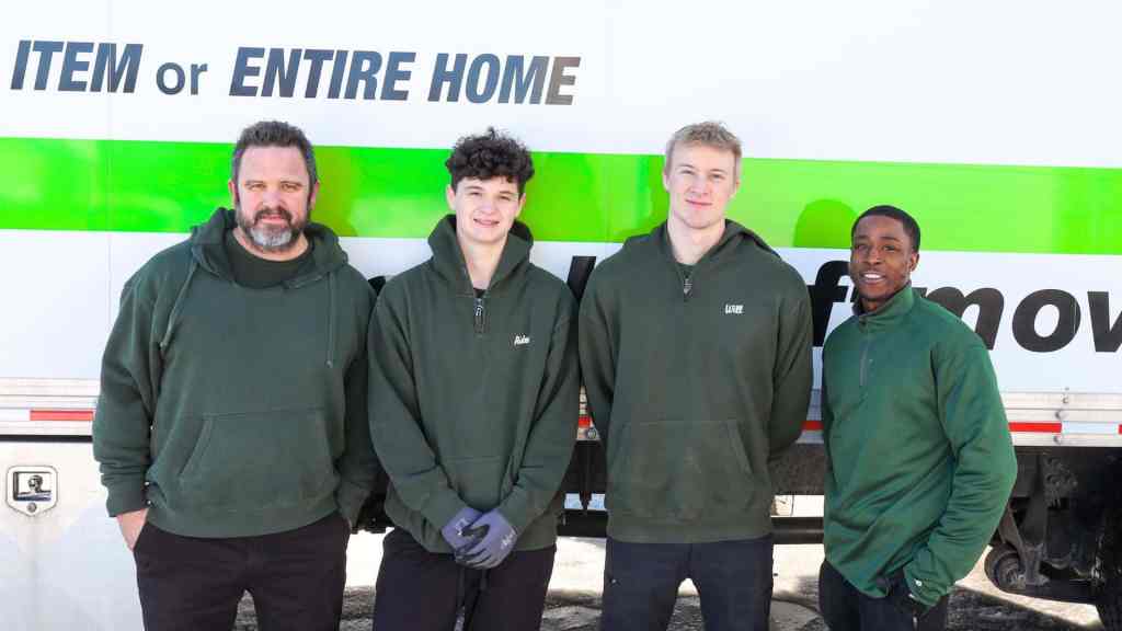 Four good stuff moving team members in front of a truck