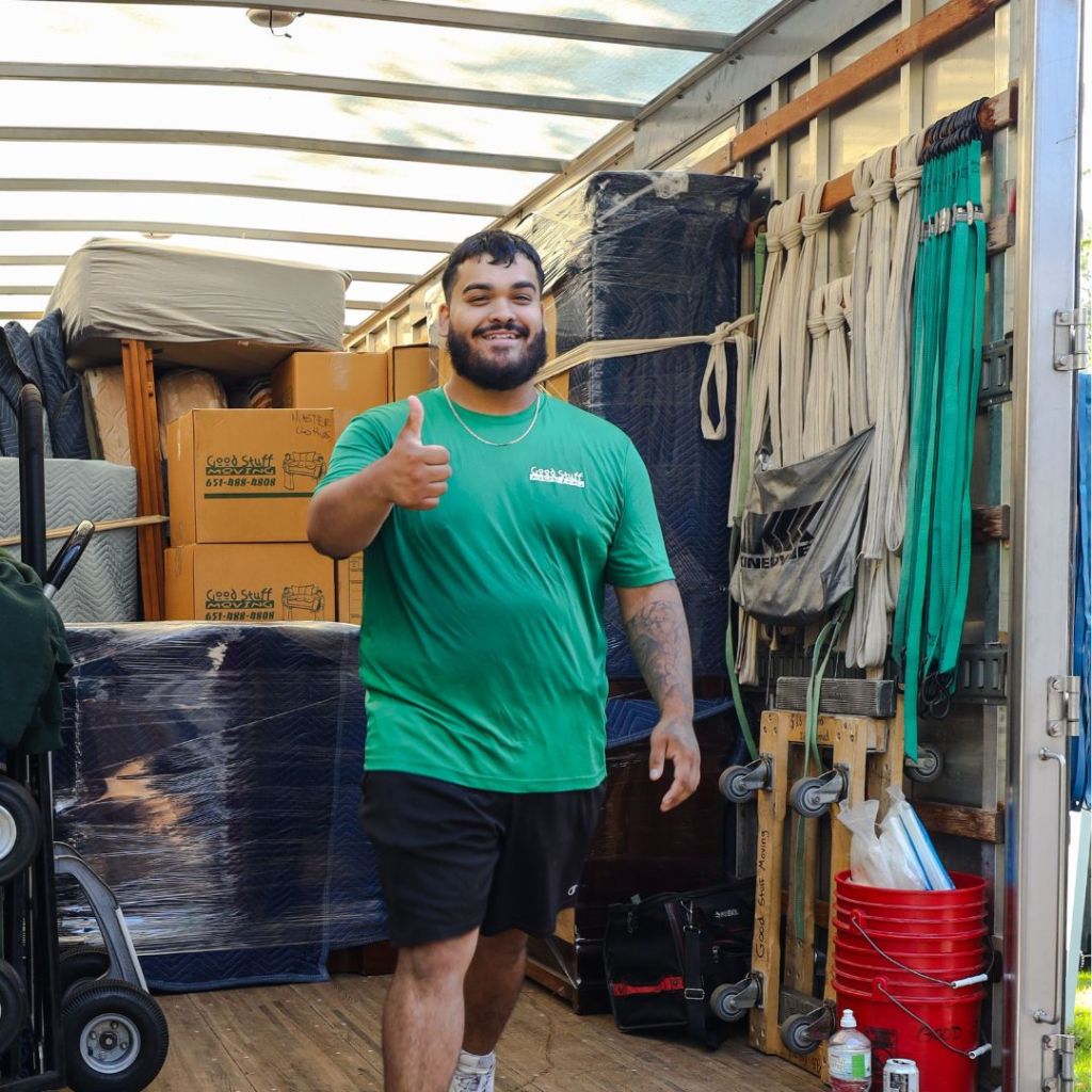a good stuff mover in the back of a moving truck giving a thumbs up