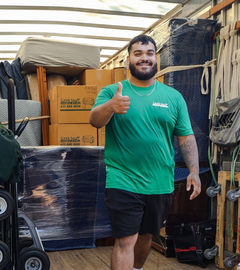 a good stuff mover giving a thumbs up in the back of a moving truck