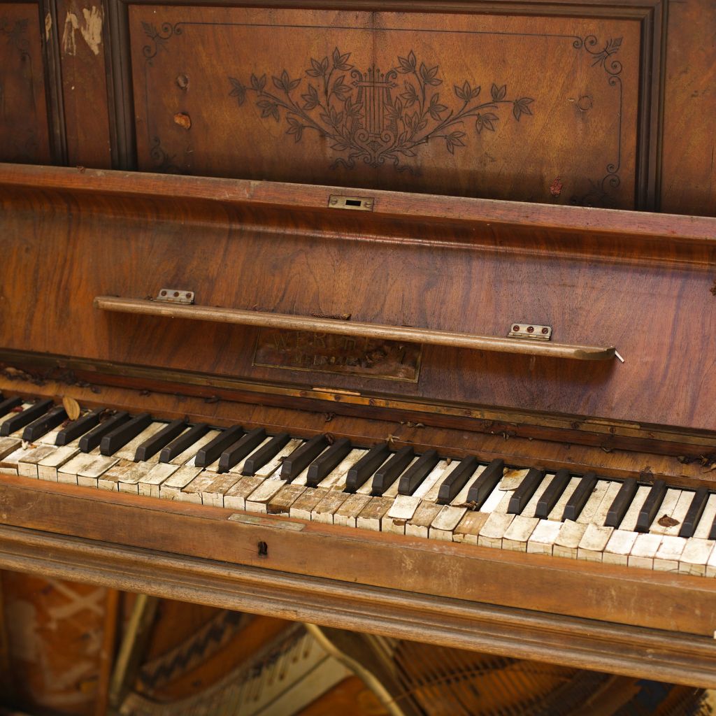 antique piano with noticeable wear